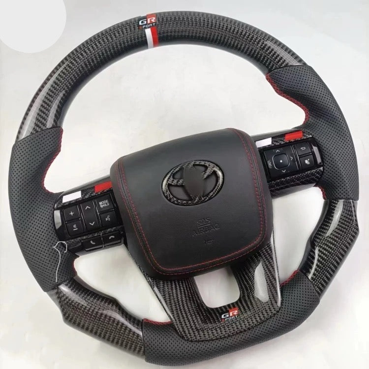 TOYOTA Hilux (2012-2024) - Carbon Fiber + Leather Steering Wheel with Airbag and Buttons