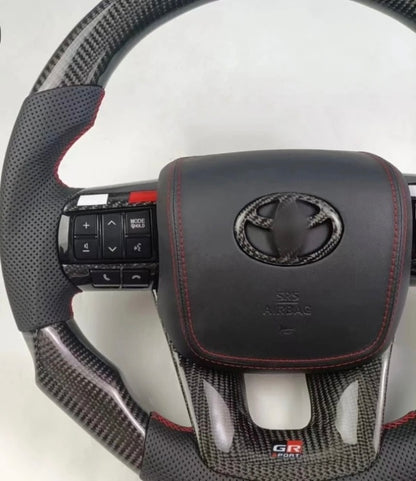 TOYOTA Hilux (2012-2024) - Carbon Fiber + Leather Steering Wheel with Airbag and Buttons